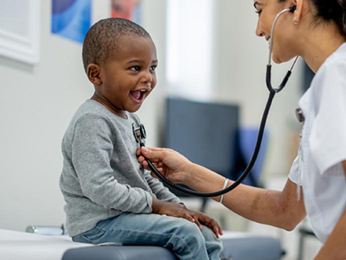 A little boy getting a check-up at a doctor's office