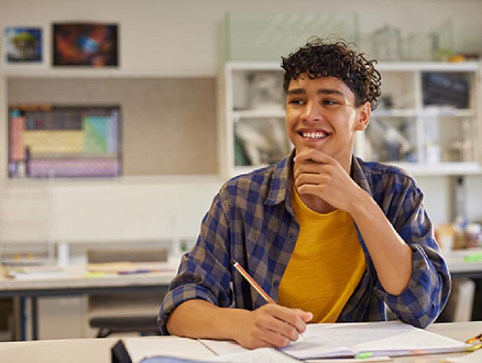 A teenage boy learning in a classroom