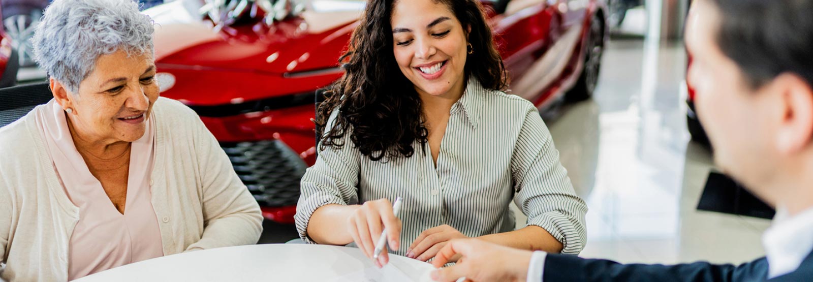 A young lady and her mother applying for a new car